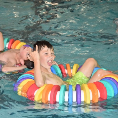Boy relaxing in the pool with a floating ring